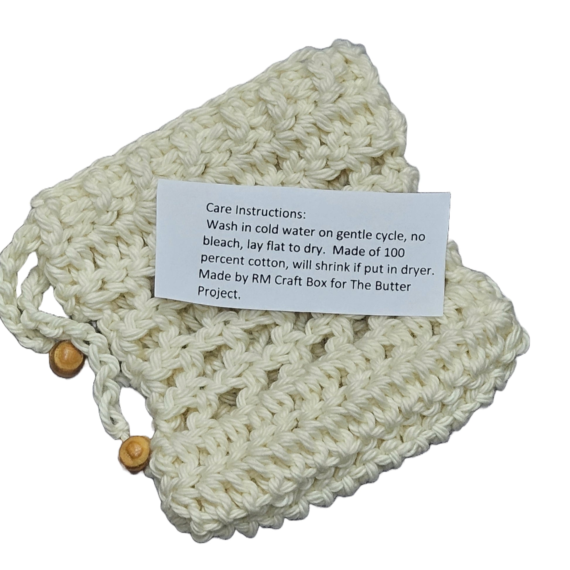 off white hand crochet cotton soap bag with decorative wood beads shown with care instructions