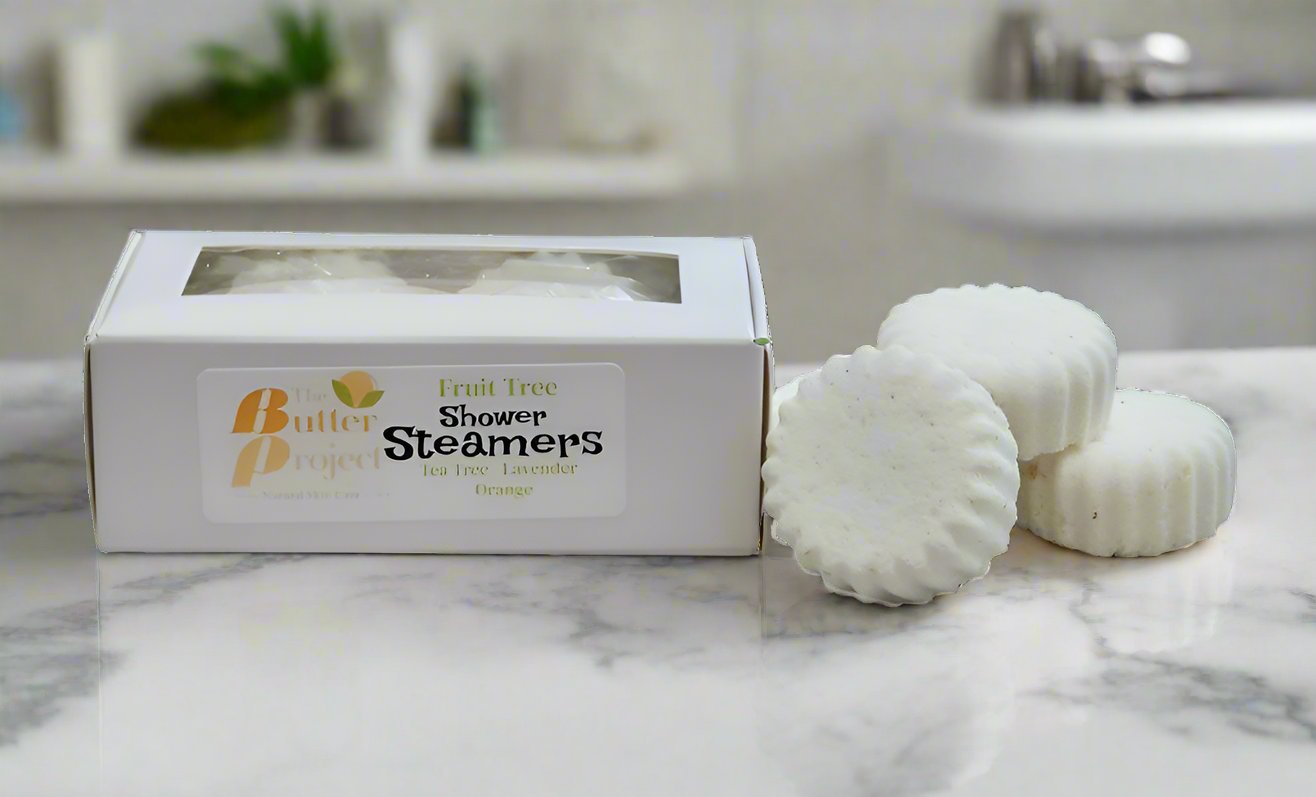 Image of a box of shower steamers and four unboxed shower steamers