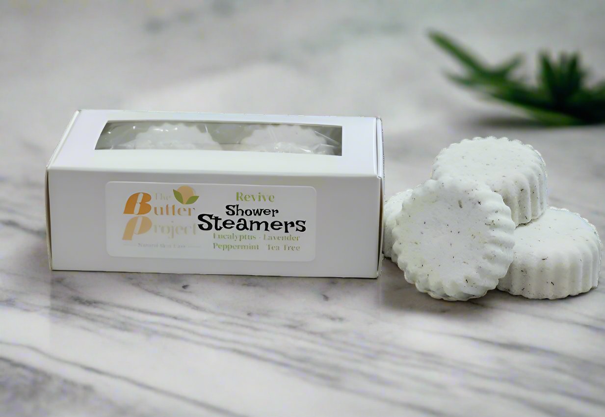 Image of box of peppermint shower steamers with four unboxed shower steamers.