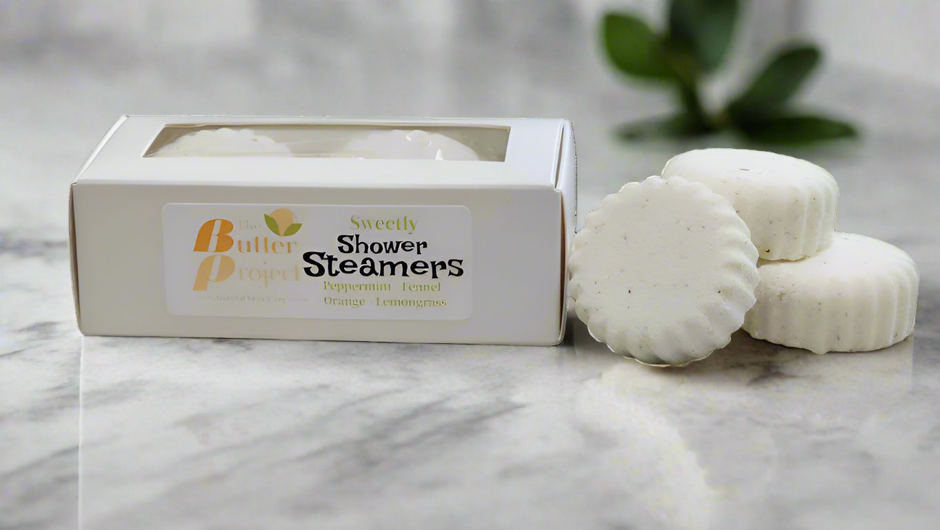 Image of box of shower steamers with four unboxed steamers.