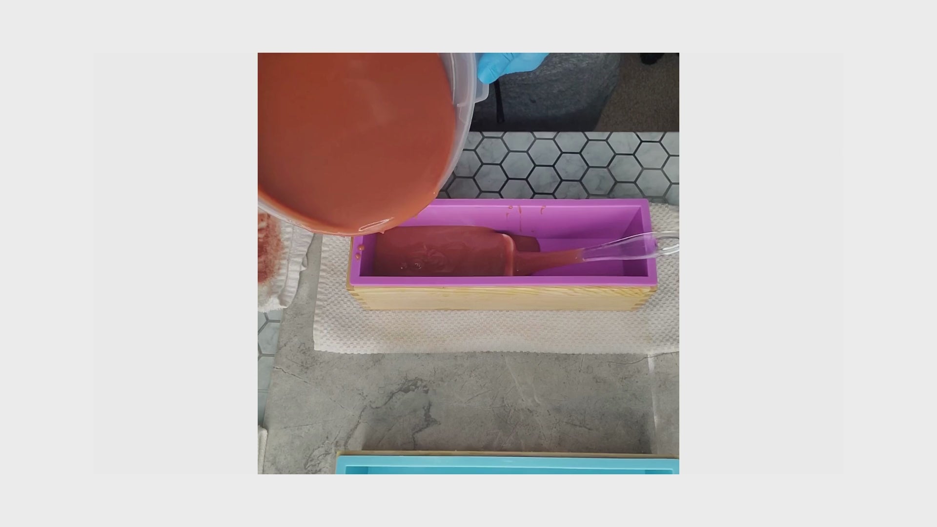 Load video: Behind the scenes with the founder carefully pouring artisanally made soap batter into a soap mold.