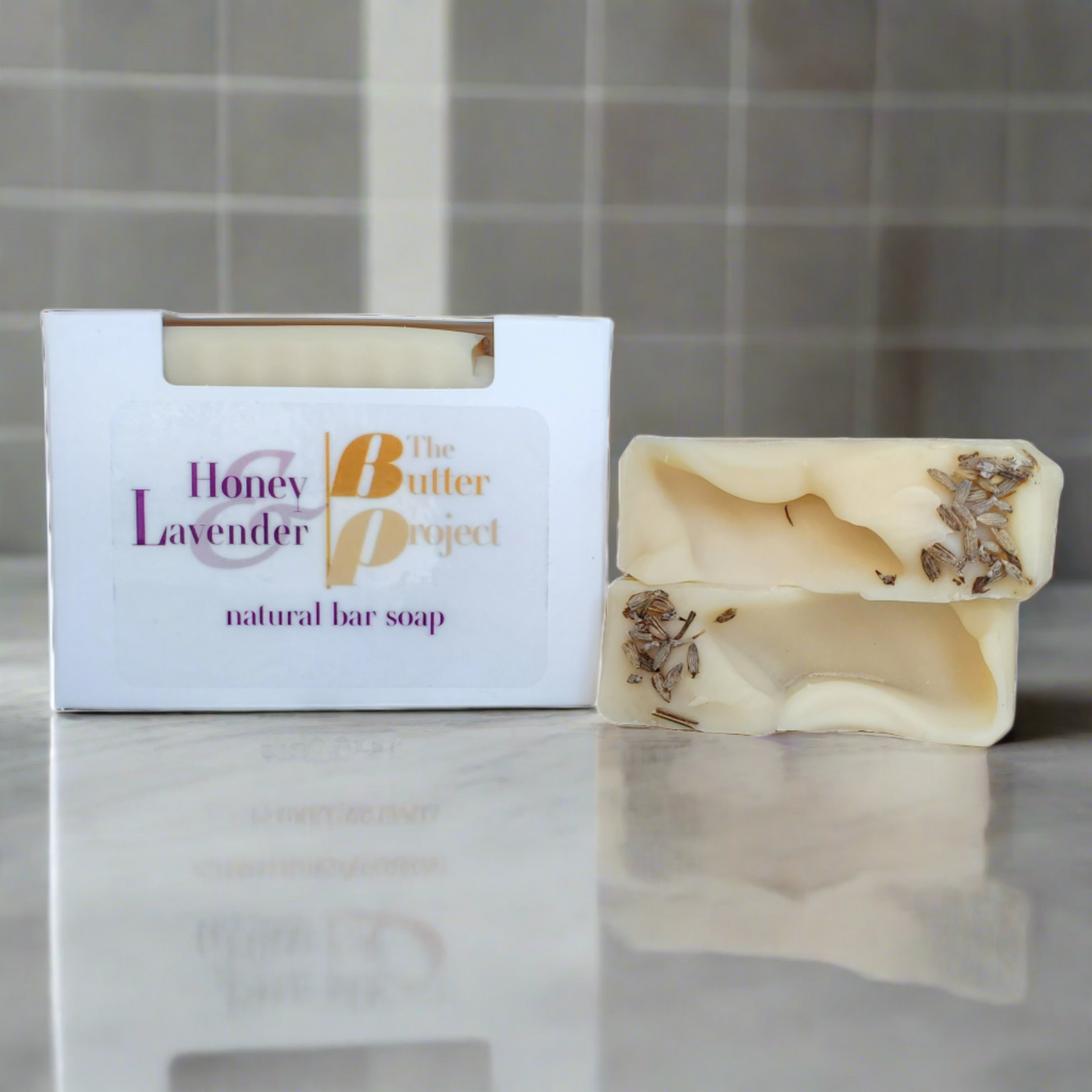 Image of Honey & Lavender Natural Bar Soap box and two bars of Honey & Lavender Natural Bar Soap from The Butter Project.